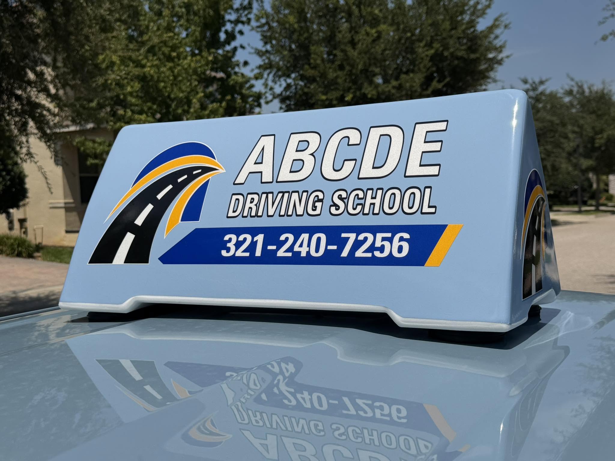 ABCDE Driving School roof sign with phone number 321-240-7256